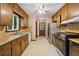 Kitchen with wood cabinets, stainless steel appliances, and retro wallpaper at 3252 Westbrook Trce, Lawrenceville, GA 30044