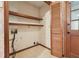 Small storage room with wood shelving, patterned tile flooring, and a wood paneled door at 3252 Westbrook Trce, Lawrenceville, GA 30044