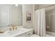 Bathroom featuring a marble vanity, brass fixtures, and a shower with gray ceramic subway tile at 3332 Old Concord Se Rd, Smyrna, GA 30082