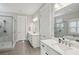 Elegant bathroom with dual vanities, marble countertops, a glass-enclosed shower, and modern fixtures at 3332 Old Concord Se Rd, Smyrna, GA 30082