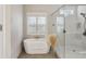 Bright bathroom featuring a soaking tub next to a glass shower with white subway tile at 3332 Old Concord Se Rd, Smyrna, GA 30082