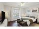 Bright bedroom with a large window, neutral decor, and plush bedding with dark hardwood floors at 3332 Old Concord Se Rd, Smyrna, GA 30082