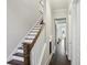 Entryway featuring hardwood floors and a staircase with a wooden handrail and white risers at 3332 Old Concord Se Rd, Smyrna, GA 30082