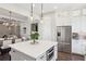 Bright kitchen with an island, stainless steel refrigerator, and view into dining area at 3332 Old Concord Se Rd, Smyrna, GA 30082