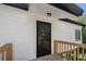 Close-up exterior of back deck with wooden railing and glass door in white siding at 5780 Bearing Way, Atlanta, GA 30349