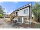 Two-story home with a deck, stone accents, and ample parking space, near lush bamboo at 5780 Bearing Way, Atlanta, GA 30349