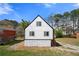 Exterior elevation of a two-story home with white siding and stone accents on the bottom half at 5780 Bearing Way, Atlanta, GA 30349