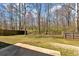 Spacious backyard features a wooden fence, mature trees, and a concrete patio, blending natural and constructed elements at 81 Summer Creek Dr, Dallas, GA 30157