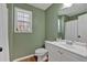 Well-lit bathroom with a window, toilet and vanity with a sink at 81 Summer Creek Dr, Dallas, GA 30157