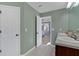 Well-lit bathroom features double sinks, white cabinets and doors, and a door opening into the bedroom at 81 Summer Creek Dr, Dallas, GA 30157