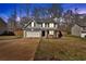 View of a two-story home with an attached garage, driveway, and well-maintained front lawn and fenced yard at 81 Summer Creek Dr, Dallas, GA 30157