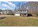 Residential street view of a two-story home with an attached garage, driveway, and lawn at 81 Summer Creek Dr, Dallas, GA 30157