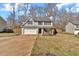 View of a two-story home with an attached garage, driveway, and well-maintained front lawn and fenced yard at 81 Summer Creek Dr, Dallas, GA 30157