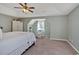 Spacious bedroom with a sitting area by the window, closet and carpet flooring at 81 Summer Creek Dr, Dallas, GA 30157