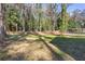 A large, grassy backyard surrounded by mature trees, offering privacy and shade at 1649 Derry Sw Ave, Atlanta, GA 30310