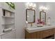 Elegant bathroom with double sinks, quartz countertops, modern fixtures, and decorative mirrors at 1649 Derry Sw Ave, Atlanta, GA 30310