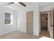 A bright and modern bedroom with a connecting bathroom, featuring wood flooring and white walls at 1649 Derry Sw Ave, Atlanta, GA 30310