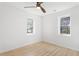 A minimalist bedroom with wood flooring, white walls and trim, with dual paned windows at 1649 Derry Sw Ave, Atlanta, GA 30310