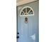 A beautiful light blue front door with decorative glass, a lion knocker, and matte black hardware at 1649 Derry Sw Ave, Atlanta, GA 30310