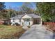 Well-lit, charming home with a covered carport and walkway leading to a light blue front door at 1649 Derry Sw Ave, Atlanta, GA 30310