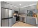 Well-lit kitchen featuring stainless steel appliances, custom cabinetry, and marble countertops at 1649 Derry Sw Ave, Atlanta, GA 30310