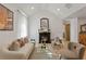 Bright living room with a decorative fireplace, modern lighting, and stylish furniture at 1649 Derry Sw Ave, Atlanta, GA 30310