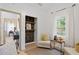 Bright sitting room area with decorative shelves, chairs, and natural light at 1649 Derry Sw Ave, Atlanta, GA 30310