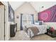 Cozy bedroom with a neutral color palette, lots of natural light, and unique wall decor at 2883 Misty Rock Cv, Dacula, GA 30019