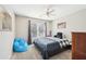 Comfortable bedroom features a large window, neutral walls, and stylish blue accents at 2883 Misty Rock Cv, Dacula, GA 30019