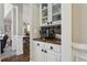 Charming coffee bar area with patterned tile backsplash, white cabinets, and a rich wood countertop at 2883 Misty Rock Cv, Dacula, GA 30019