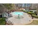 Resort-style community pool with a splash fountain, pool house, and ample deck space at 2883 Misty Rock Cv, Dacula, GA 30019
