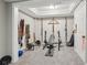 Basement gym with workout equipment, weights, a punching bag, and wall-mounted straps at 2883 Misty Rock Cv, Dacula, GA 30019