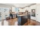 Well-lit kitchen featuring an island, stainless steel appliances, a brick backsplash, and white upper and black lower cabinets at 2883 Misty Rock Cv, Dacula, GA 30019