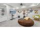 Basement recreation room with TV, lounge chairs, a workout bike, and built-in cabinetry at 2883 Misty Rock Cv, Dacula, GA 30019