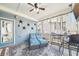 Inviting screened porch with blue accents, comfortable seating, and views of the backyard at 2883 Misty Rock Cv, Dacula, GA 30019