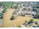 Aerial view of the home and neighborhood showing lakefront location with mature trees at 5529 Camden Lake Pointe Nw, Acworth, GA 30101
