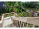 Wooden deck offering scenic views of the lush backyard and tranquil lake at 5529 Camden Lake Pointe Nw, Acworth, GA 30101