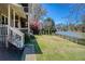 Backyard featuring brick steps to a porch and a view of lake access and fence at 5529 Camden Lake Pointe Nw, Acworth, GA 30101