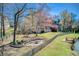 Spacious backyard featuring a fenced yard, a play set, and a fire pit area by the water at 5529 Camden Lake Pointe Nw, Acworth, GA 30101