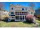 Expansive backyard with tiered screened porches, complemented by lush landscaping and a well-maintained lawn at 5529 Camden Lake Pointe Nw, Acworth, GA 30101