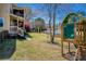 Backyard with play set, steps to covered porch and fenced backyard with a lake view at 5529 Camden Lake Pointe Nw, Acworth, GA 30101