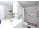 Well-lit bathroom with white vanity, framed mirror, tiled shower with grab bars, and convenient accessibility features at 5529 Camden Lake Pointe Nw, Acworth, GA 30101