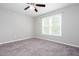 Bright, airy bedroom with neutral carpet, a ceiling fan and natural light from a large window at 5529 Camden Lake Pointe Nw, Acworth, GA 30101