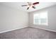 Sun-lit bedroom boasts neutral carpet, a ceiling fan and a large window at 5529 Camden Lake Pointe Nw, Acworth, GA 30101