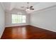Bright bedroom featuring hardwood floors, neutral walls, and a ceiling fan at 5529 Camden Lake Pointe Nw, Acworth, GA 30101