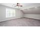 Spacious bedroom featuring a ceiling fan, large window, and plush gray carpet at 5529 Camden Lake Pointe Nw, Acworth, GA 30101