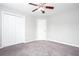 Bedroom with neutral carpet, a ceiling fan and two closets at 5529 Camden Lake Pointe Nw, Acworth, GA 30101