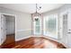 Breakfast nook with hardwood floors, modern chandelier, wainscoting, and bright windows at 5529 Camden Lake Pointe Nw, Acworth, GA 30101
