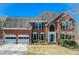 Classic brick home with a well-manicured lawn, attached two car garage and welcoming front entrance at 5529 Camden Lake Pointe Nw, Acworth, GA 30101