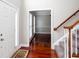 Inviting foyer with hardwood floors, a staircase, and a view into an adjacent room at 5529 Camden Lake Pointe Nw, Acworth, GA 30101
